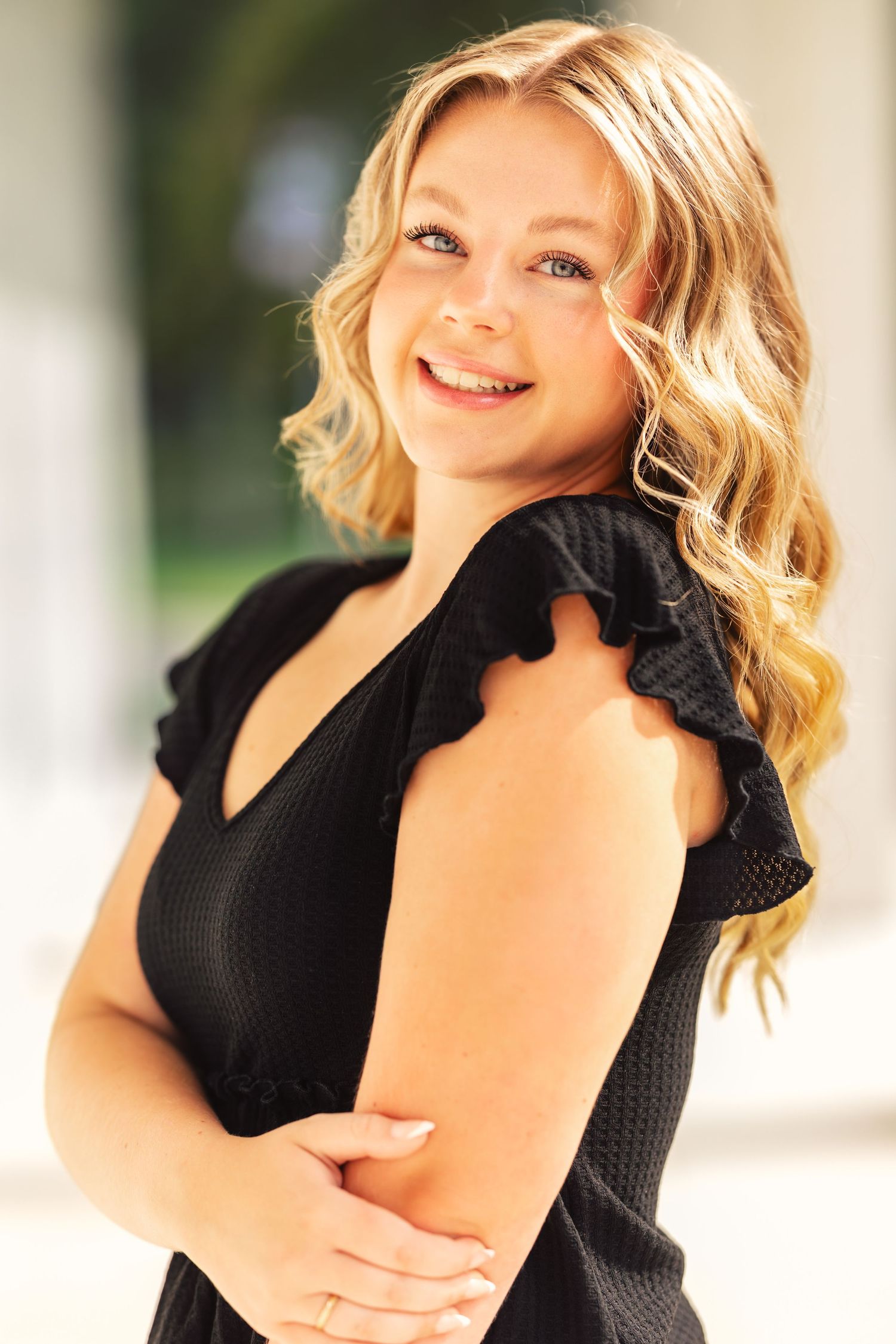 Portrait series showing someone in a black top with styled blonde hair against a light background.