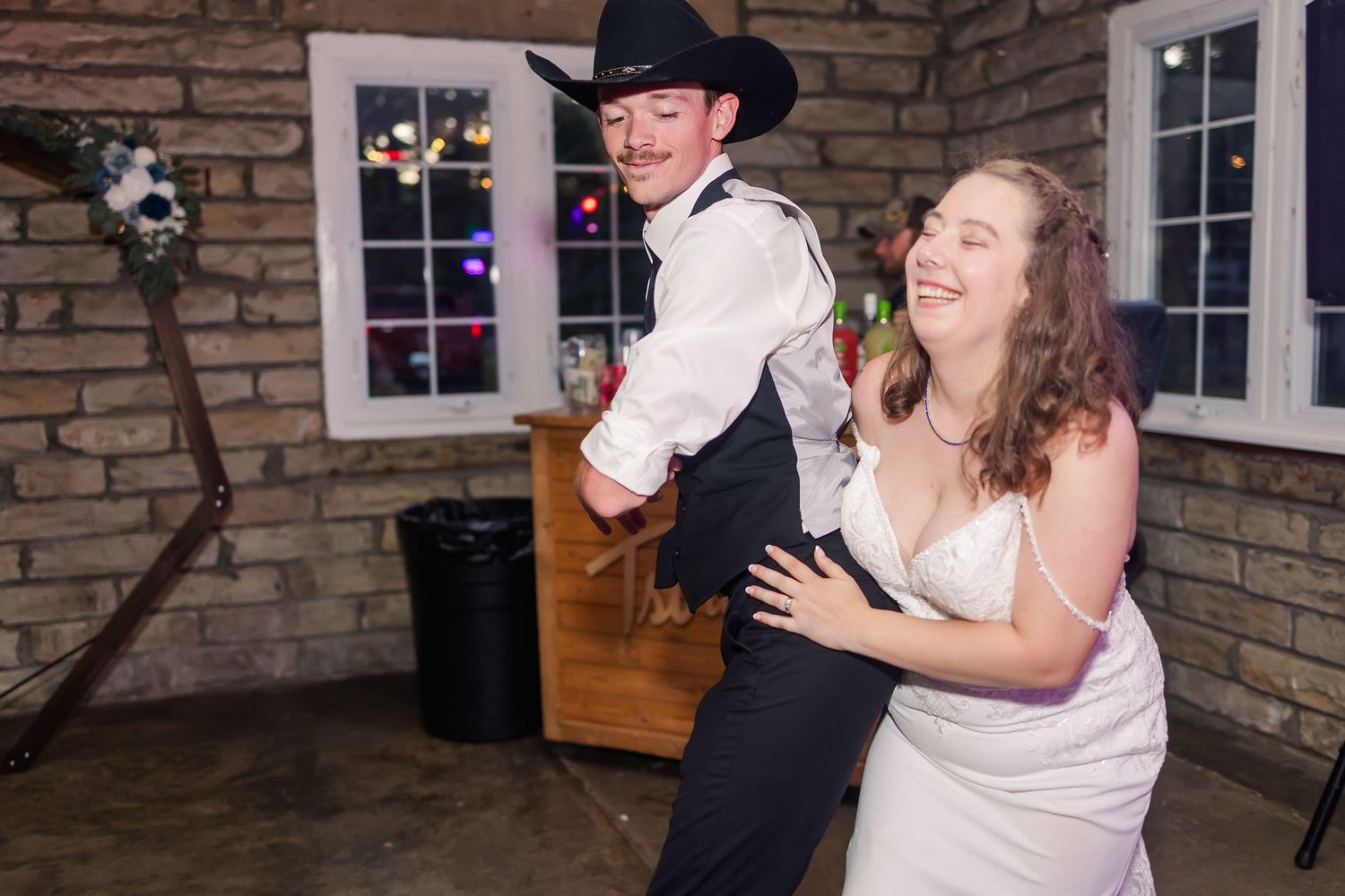 Wedding reception dance features western-themed celebration with cowboy attire.