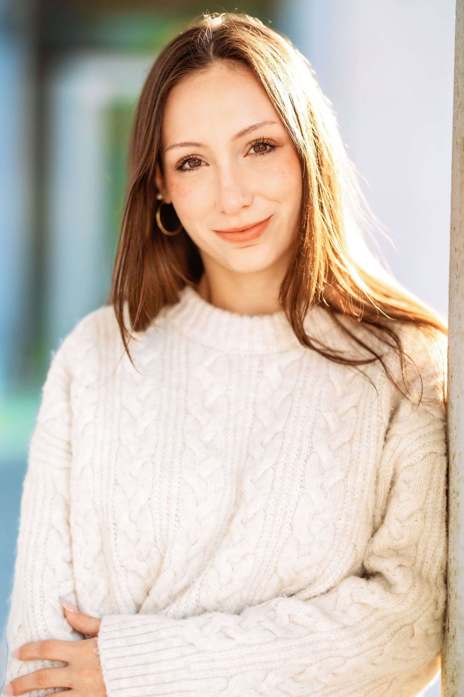 Portrait series in soft lighting featuring a white cable knit sweater.