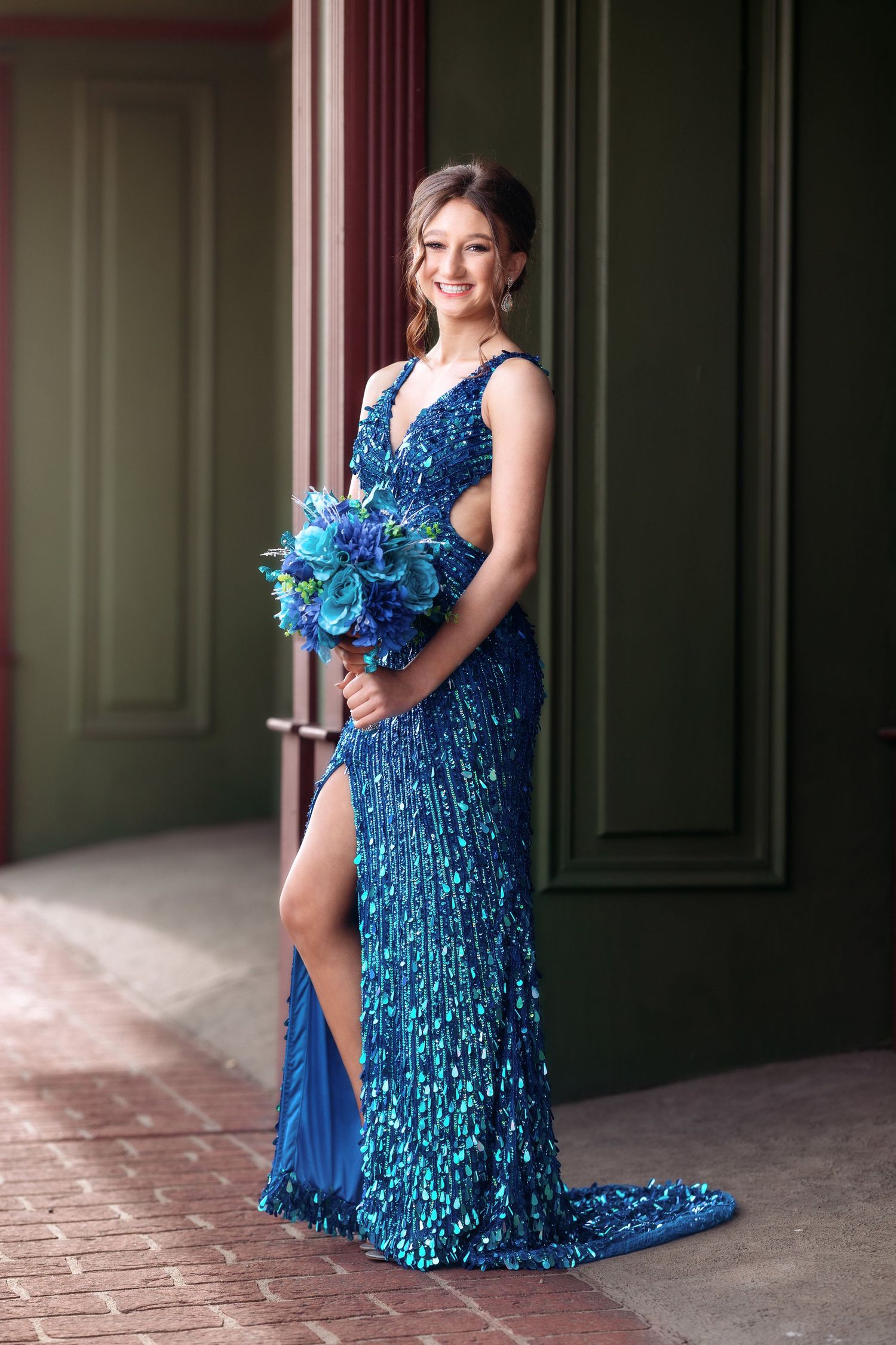 Sparkling blue sequined formal gown photographed in an elegant indoor setting.