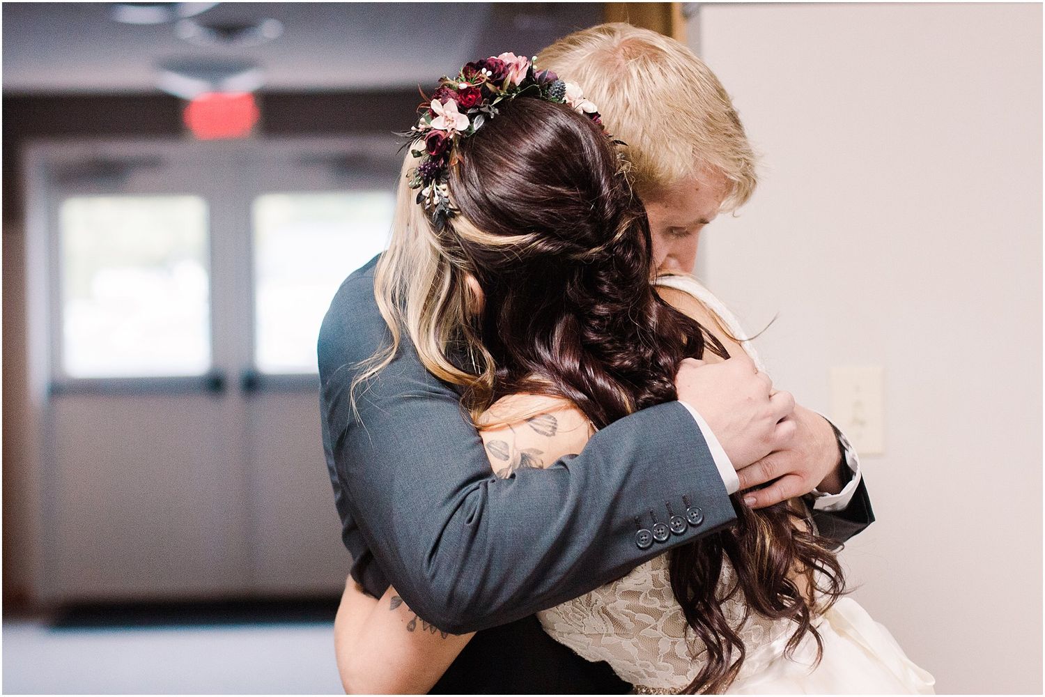 Emotional embrace between newlyweds during their wedding celebration.
