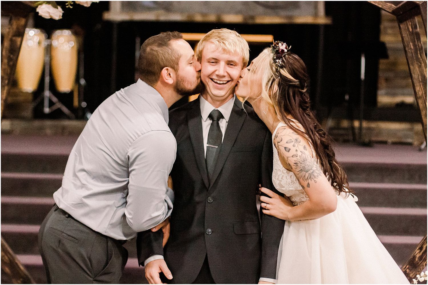 Candid moment of celebration and joy captured during an outdoor wedding ceremony.