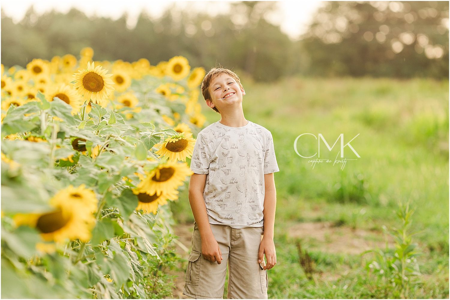 A joyful portrait in a blooming sunflower field during golden hour.