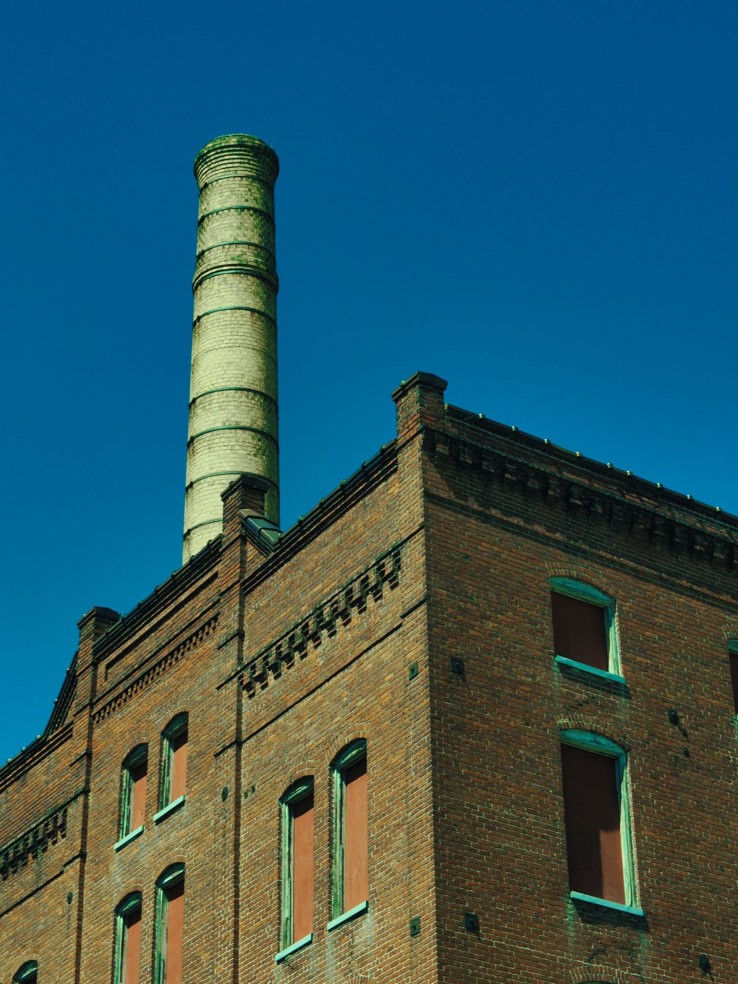 A repurposed factory and smoke stack in downtown Danville, Virginia. Showing the intricate brickwork and early 1900's details.