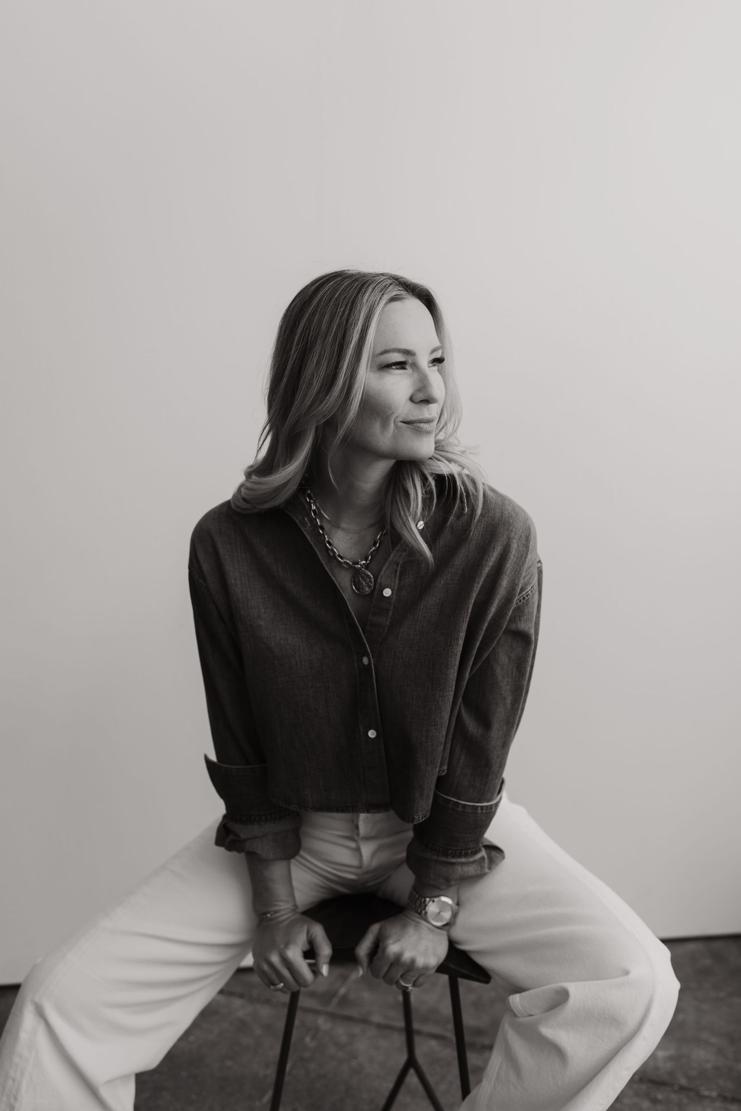 Casual business portraits showing person in dark shirt and white pants.