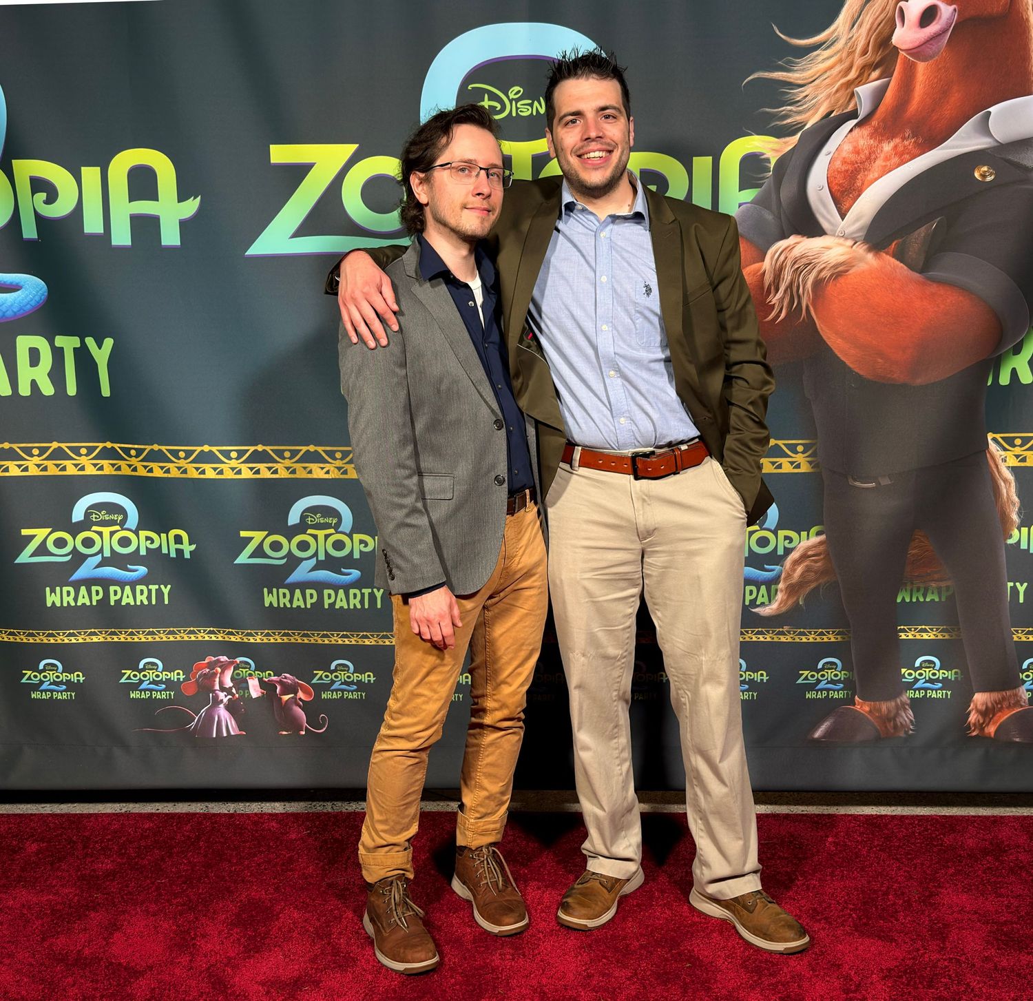 Movie premiere event backdrop with Zootopia branding and promotional displays.