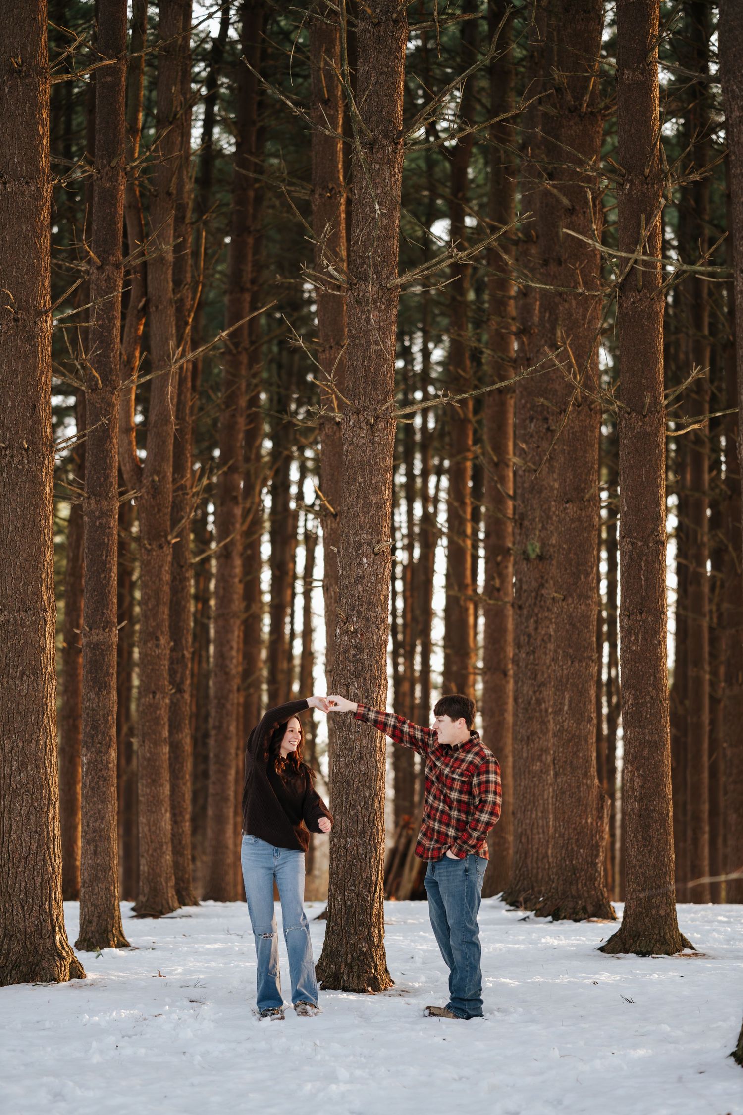 A playful winter photoshoot in a snowy pine forest.