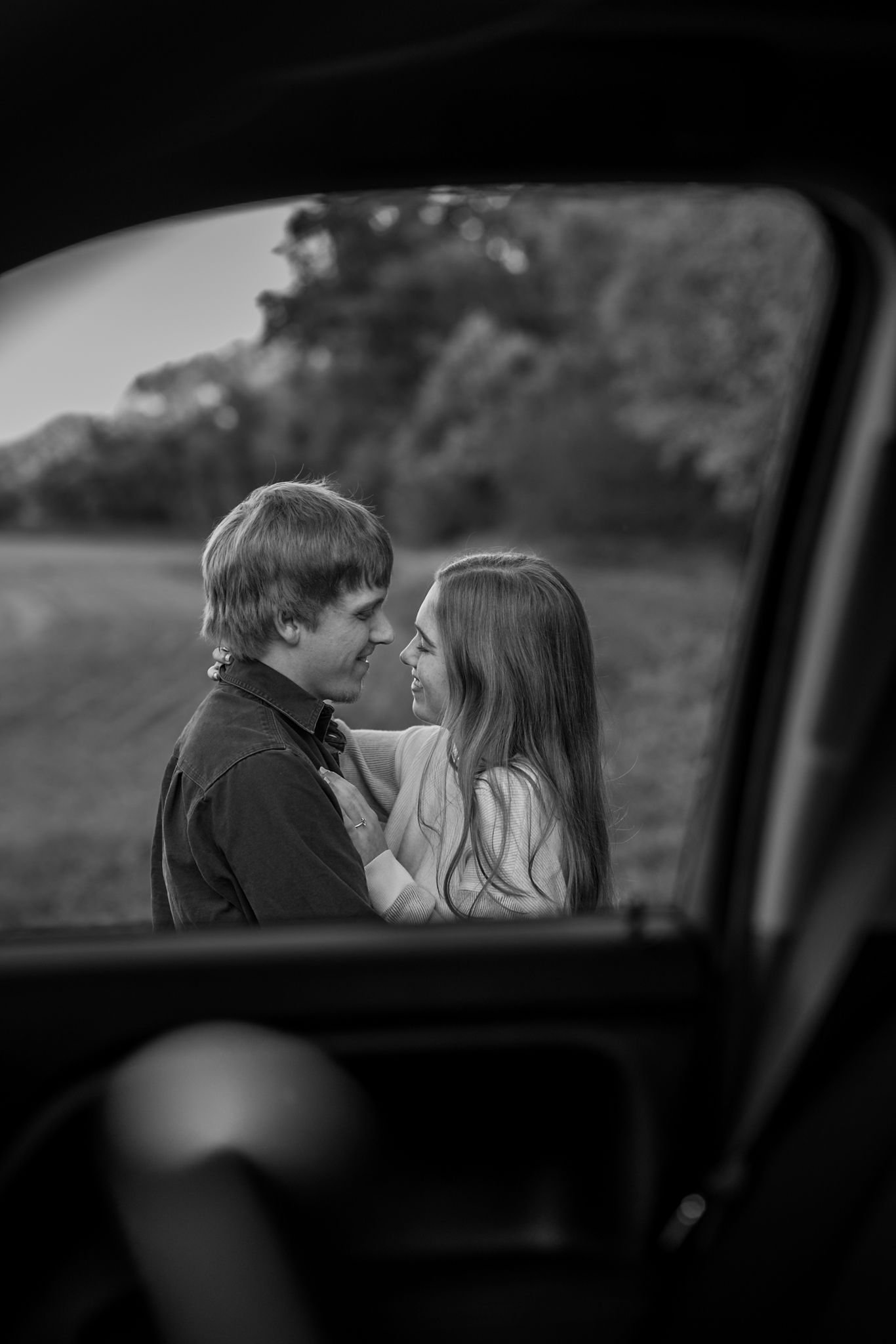 Black and white sequence captured through car window showing romantic couple interaction.