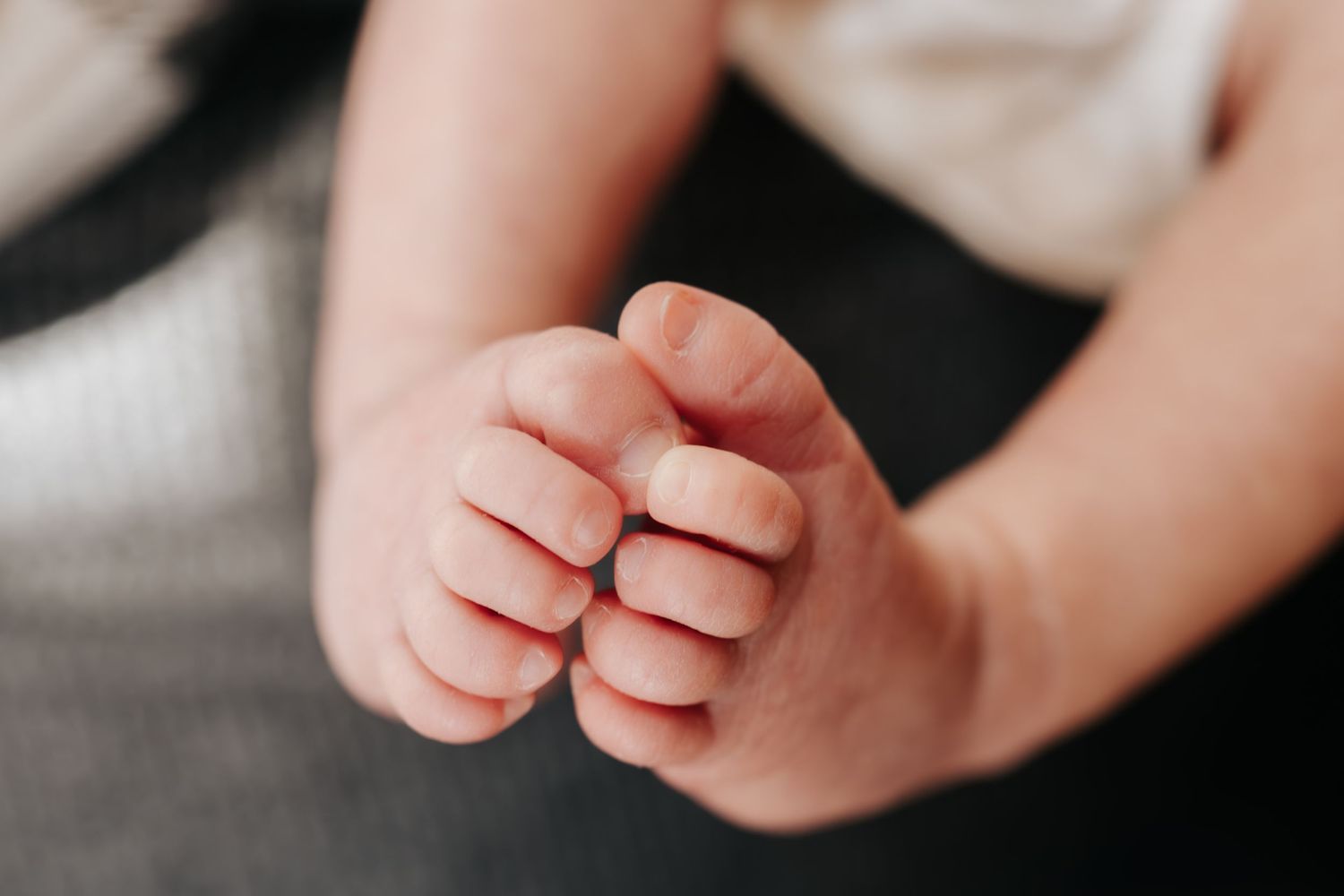 Close-up shot of hands with rings showing intimate connection.