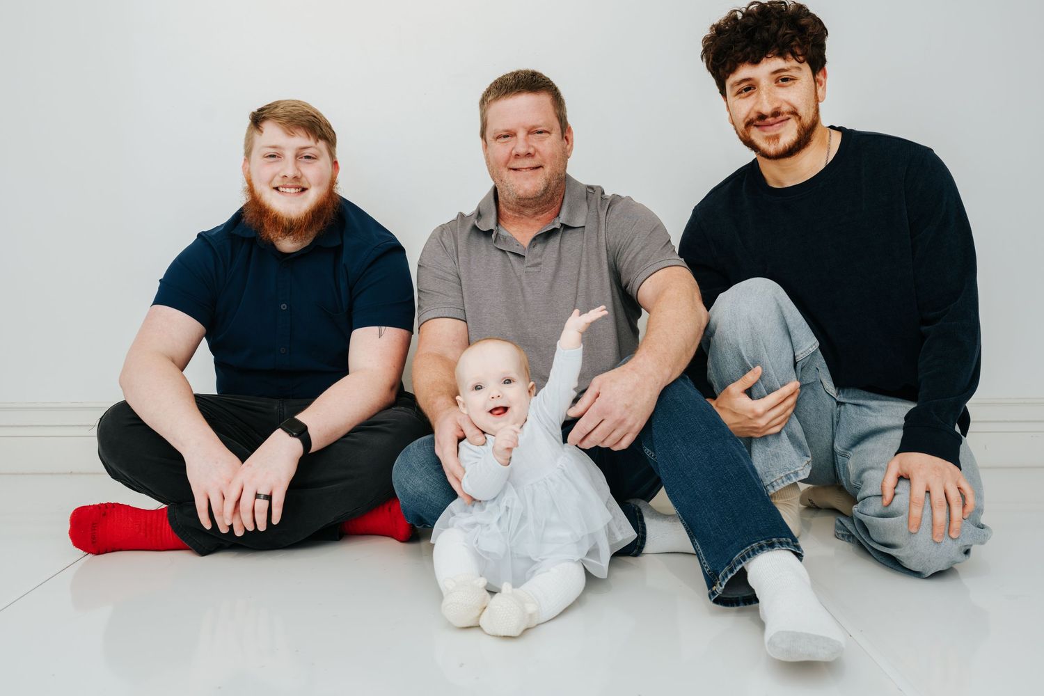 A series of casual family portrait photos showing multiple generations sitting together against a light gray background.