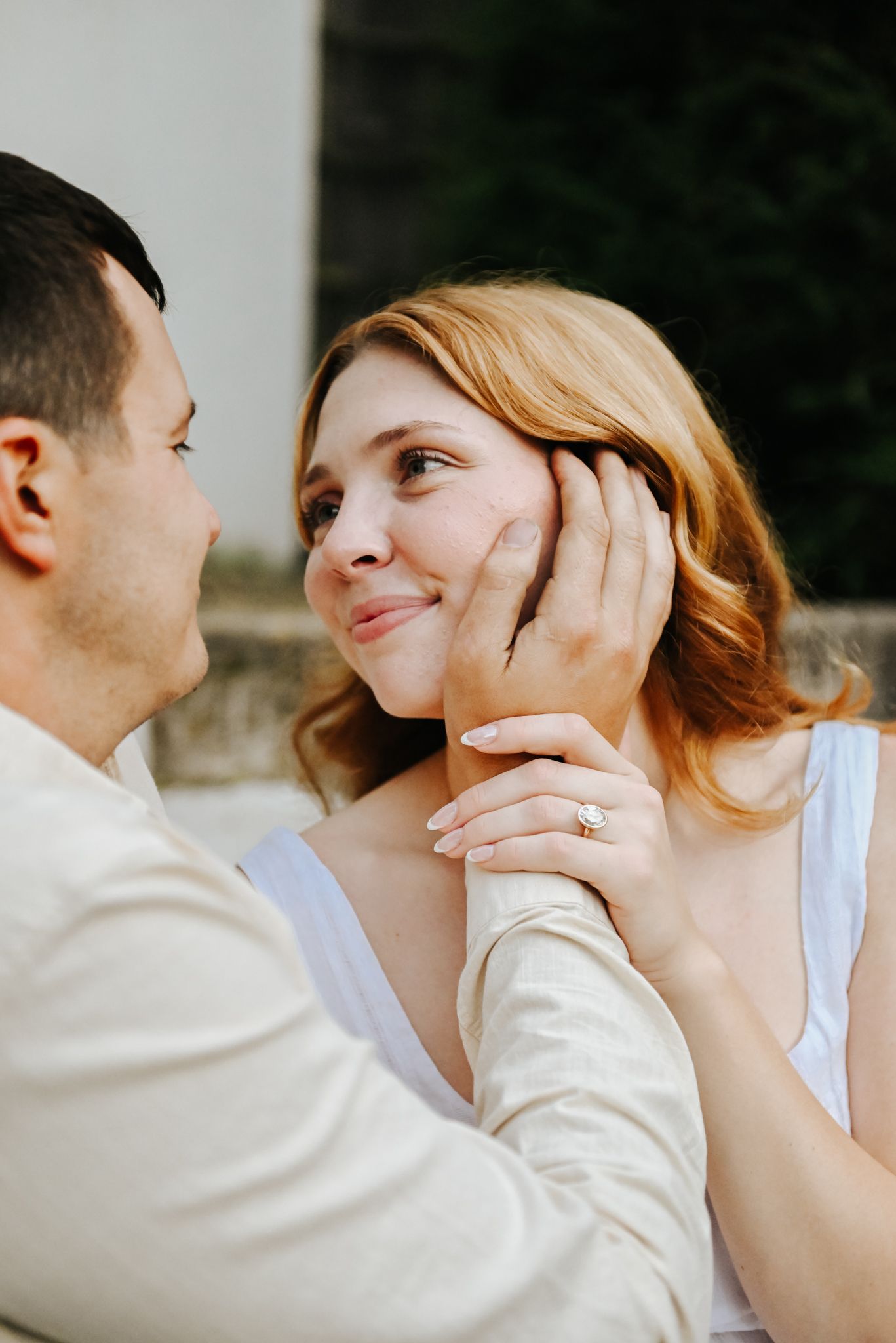 Intimate couple portrait sequence showing tender moments and gentle touches against a light background.