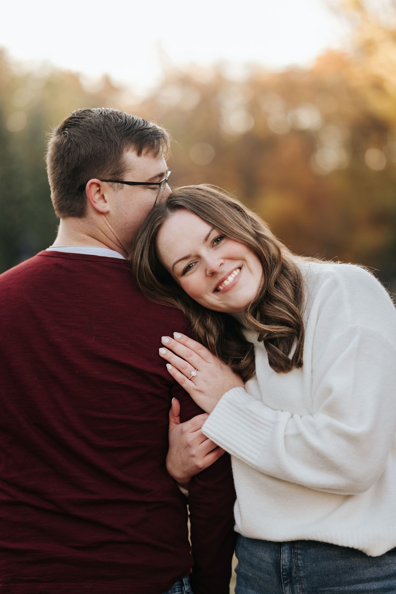 Autumn sunset couple photoshoot showing romantic embraces in warm evening light.