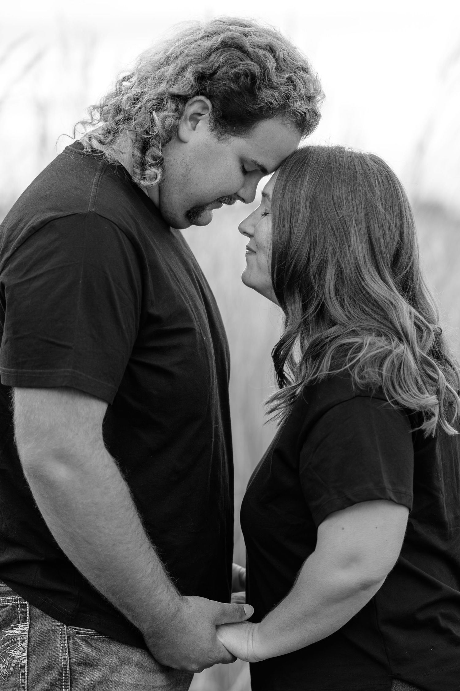 Black and white intimate portrait series showing tender moments between couple.