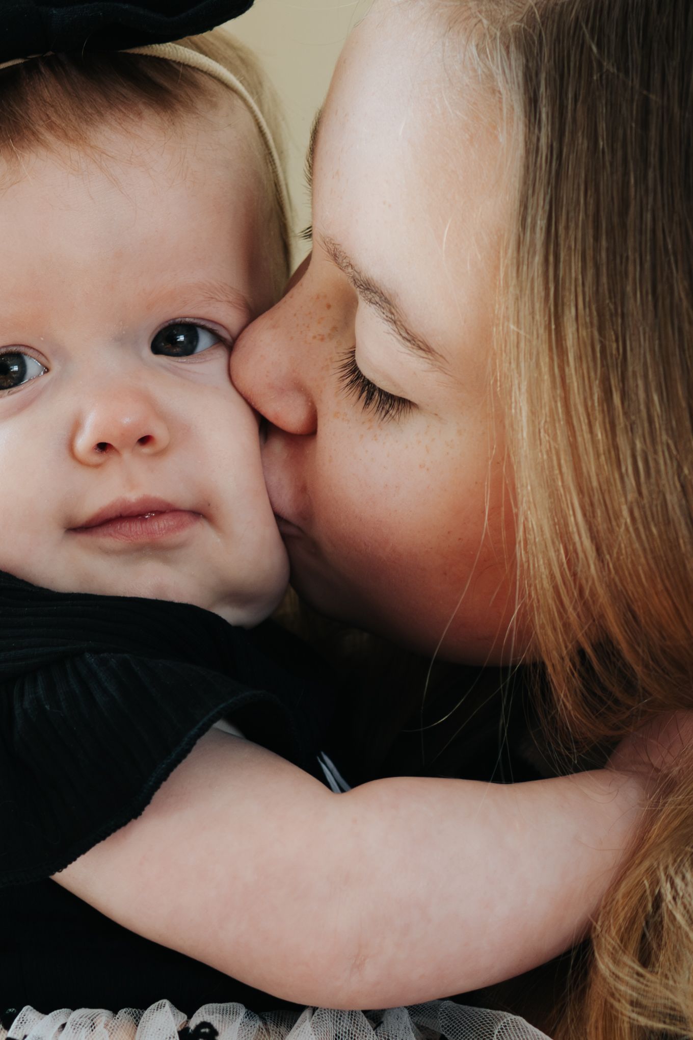 Intimate close-up portrait showing tender moment between two people.