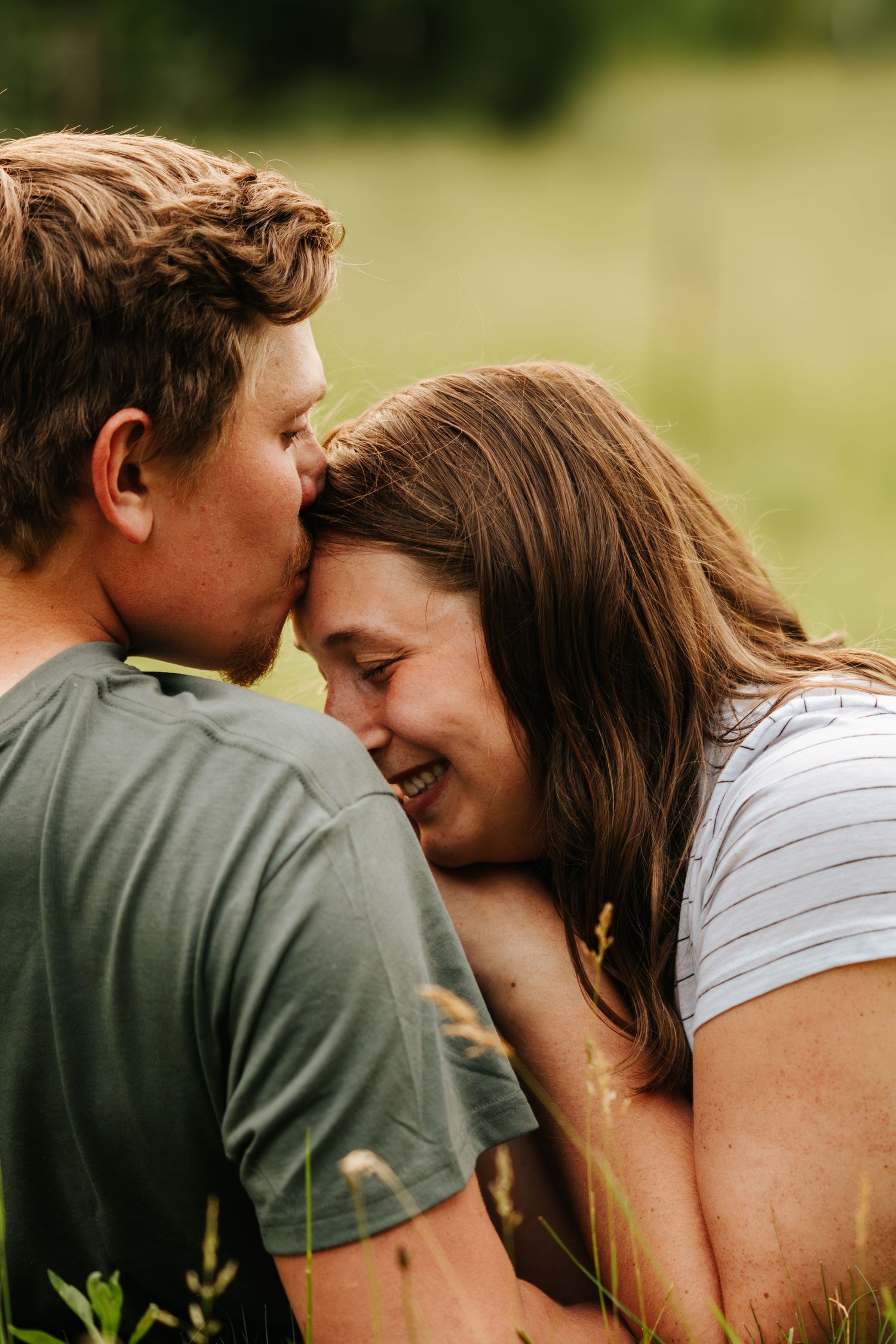 Playful outdoor couple photoshoot sequence showing intimate moments in natural setting.