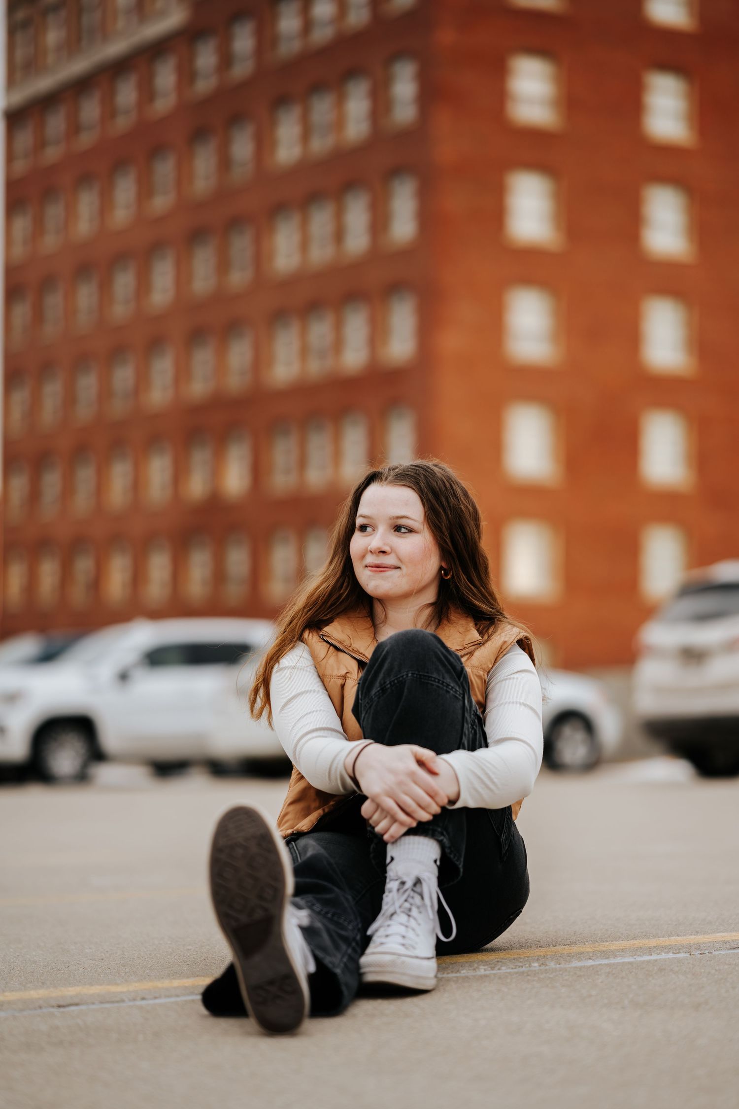 Series of casual poses on pavement against a red brick building backdrop.