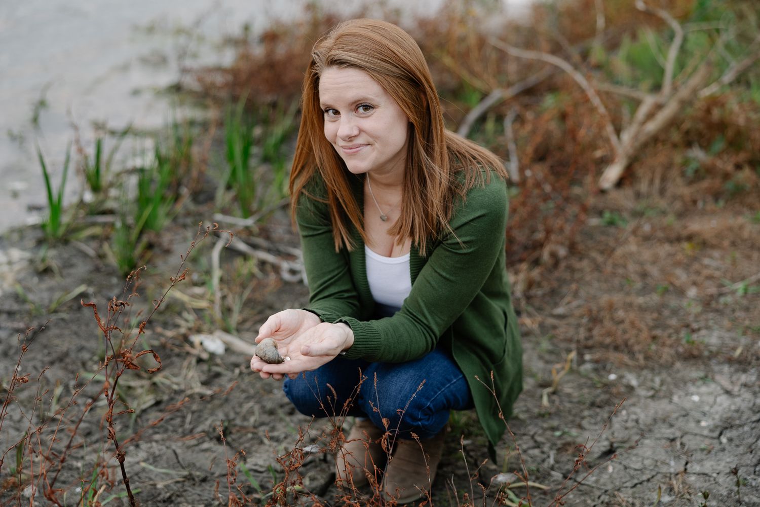 Casual portrait by the waterfront with natural elements.