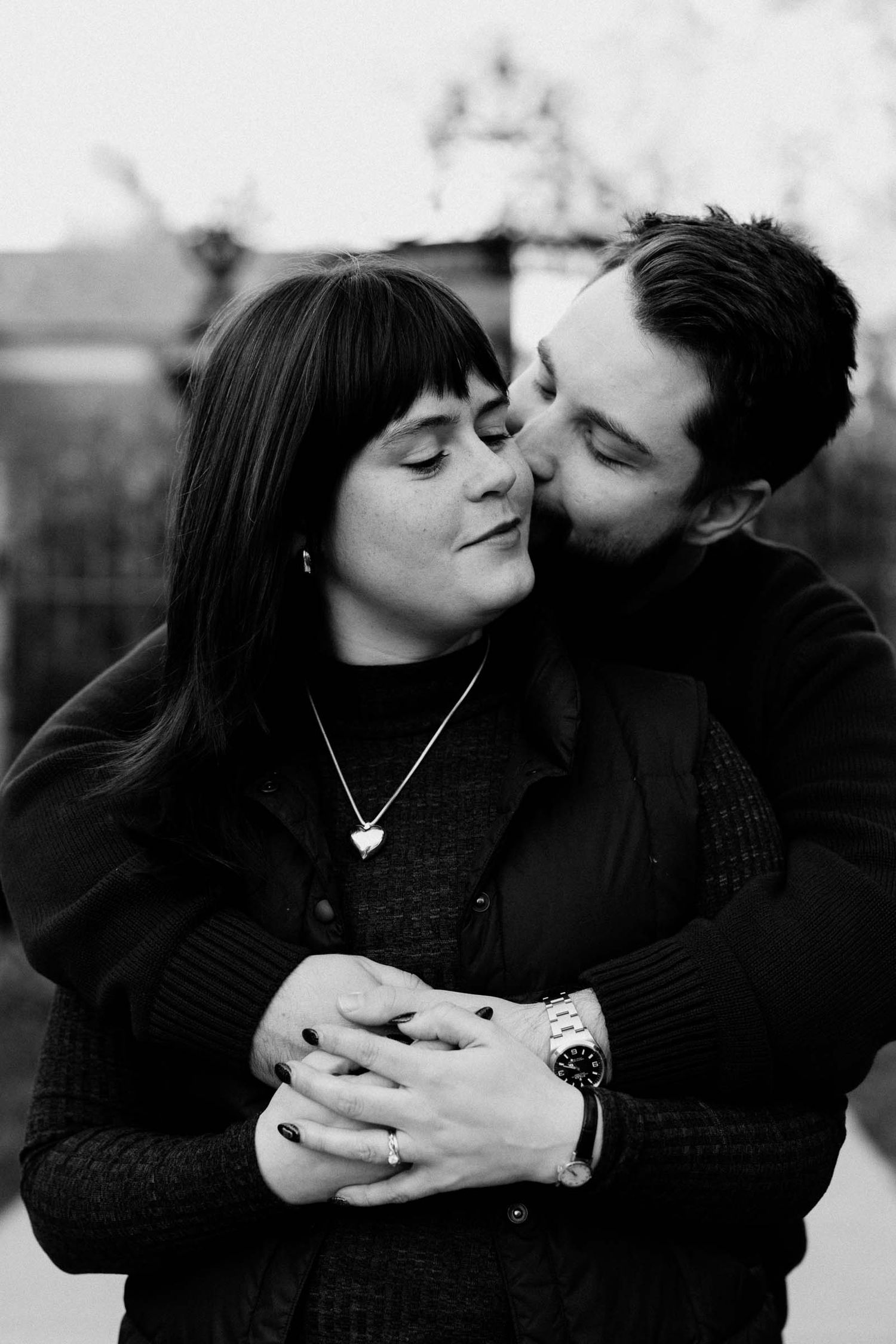 Intimate black and white portraits of couple embracing and sharing romantic moments.