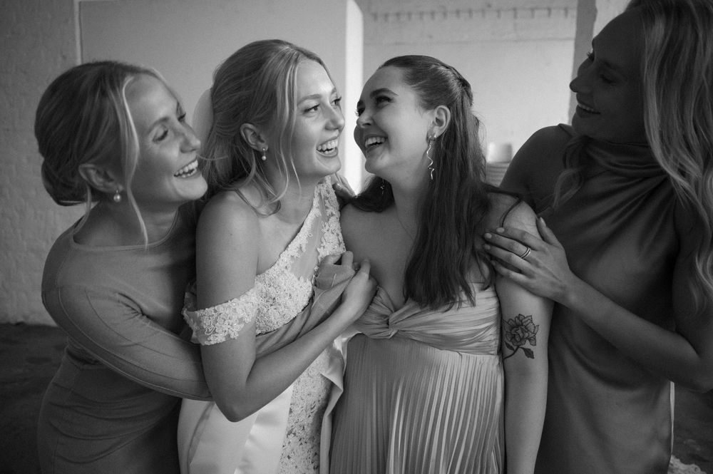 Black and white candid moment of celebration at a wedding reception.