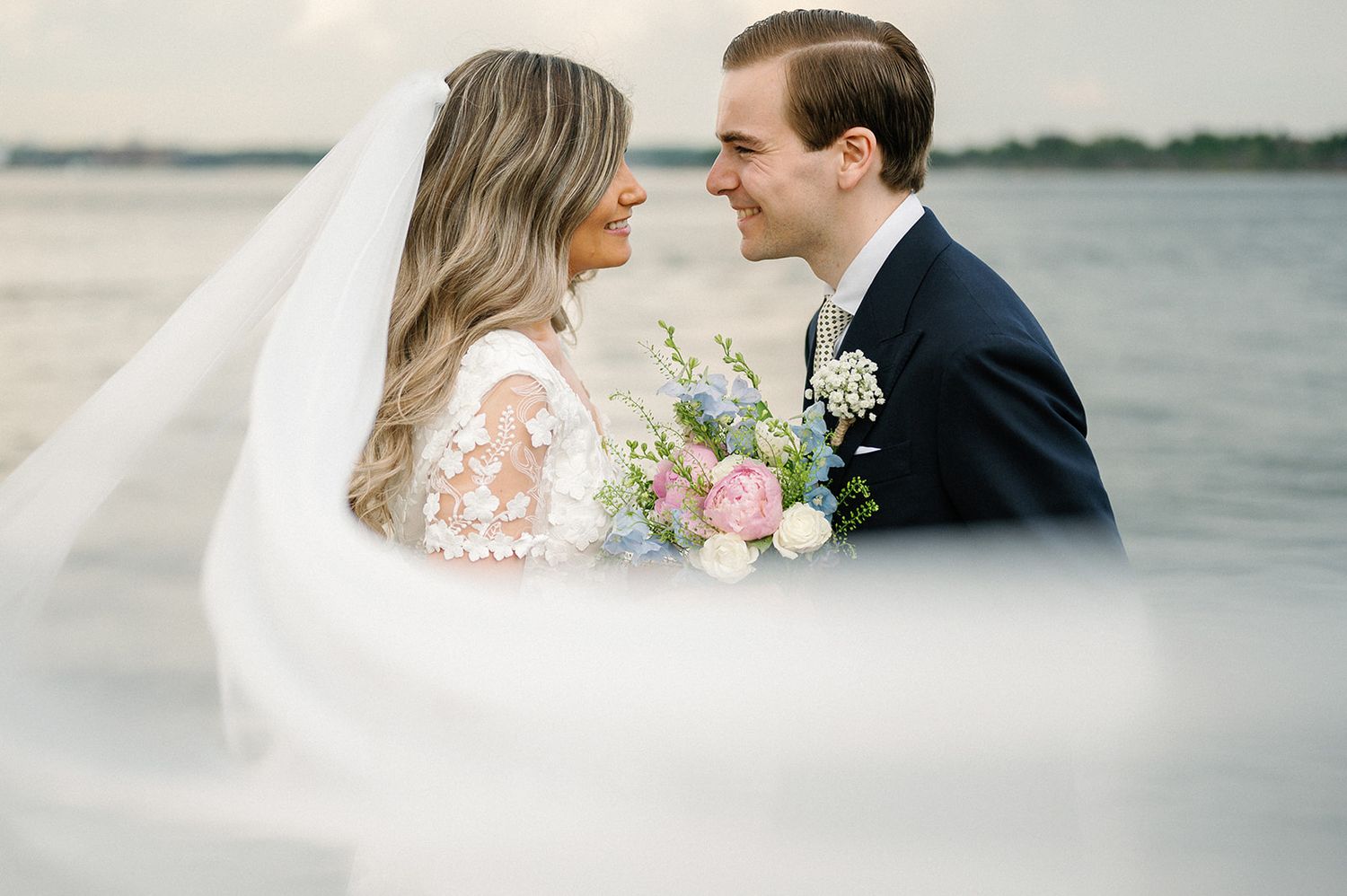 Artistic black and white wedding portraits showing romantic moments by the ocean.