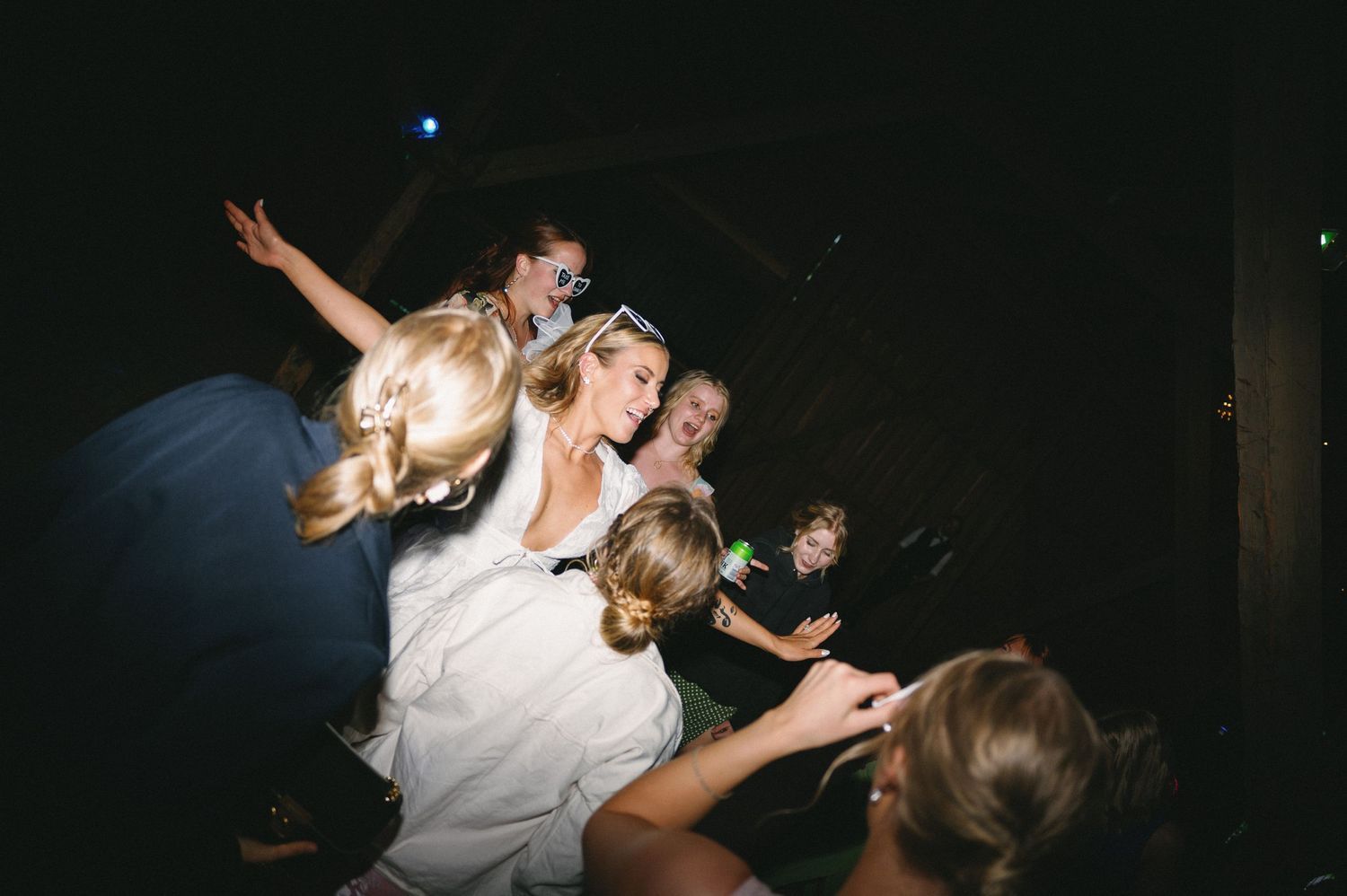 Energetic dance party scene with guests enjoying themselves under dim lighting.