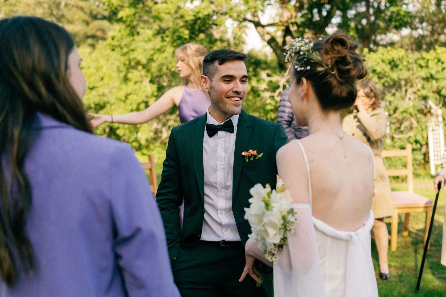 A candid wedding moment captured during an outdoor spring celebration.