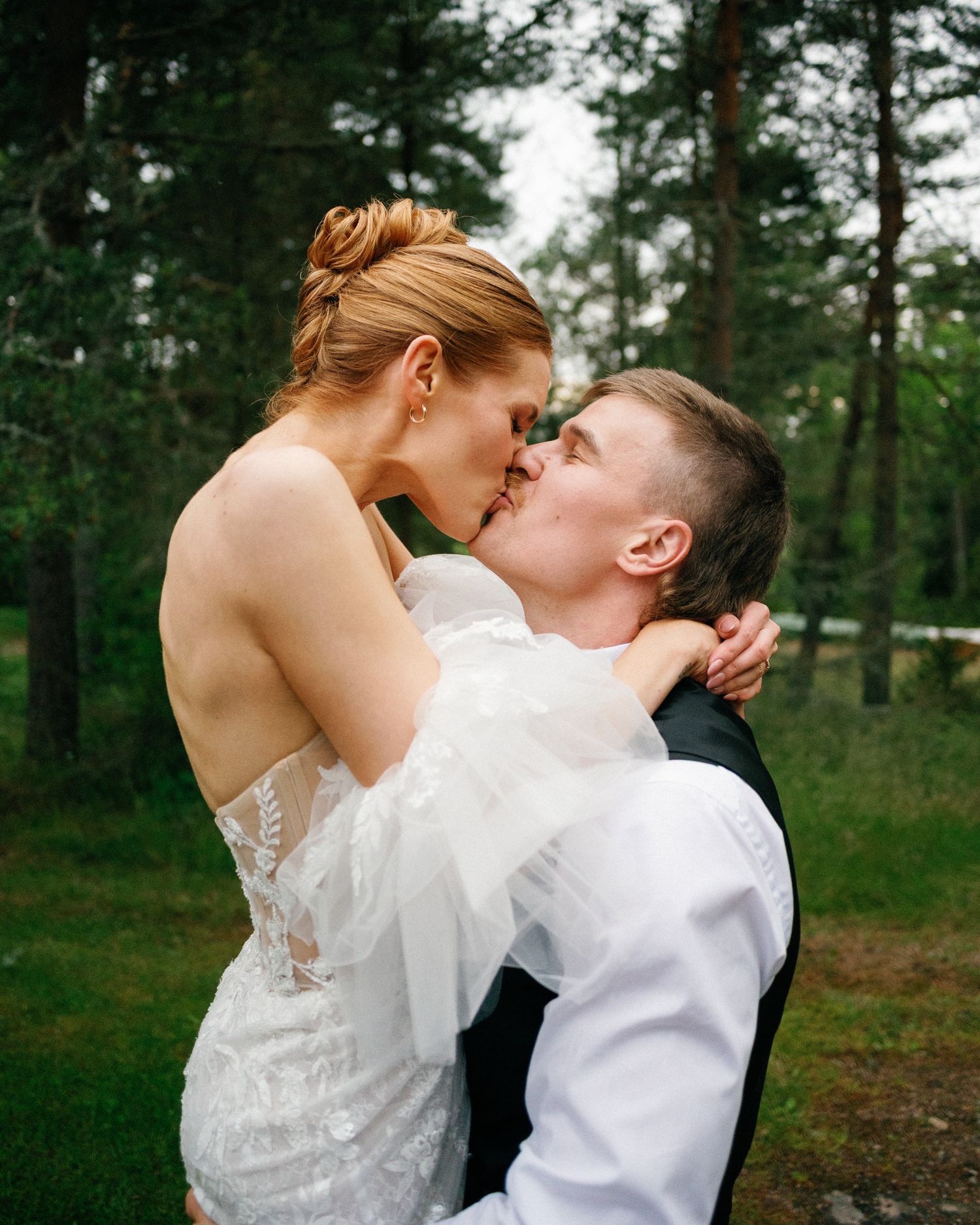 Romantic outdoor wedding photos captured in a pine forest setting.