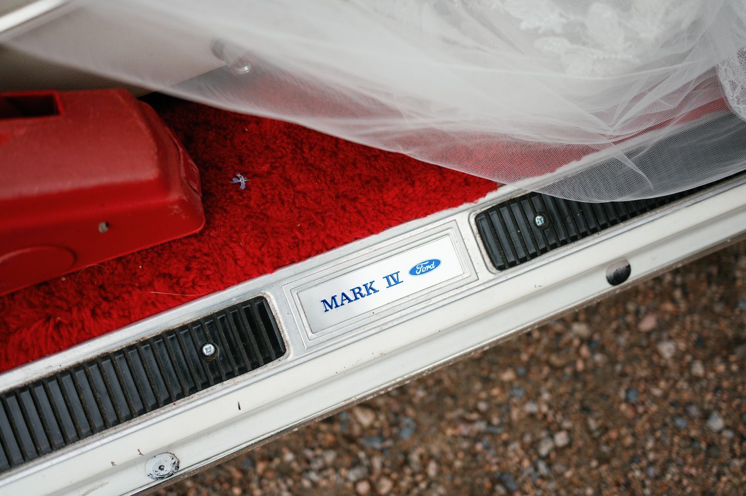 Close-up detail of a vintage car's chrome trim and door panel.
