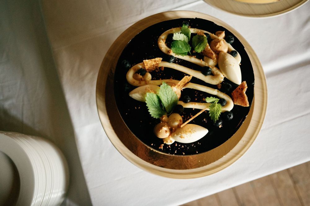 Elegant plated dishes with garnishes served at a formal wedding reception.