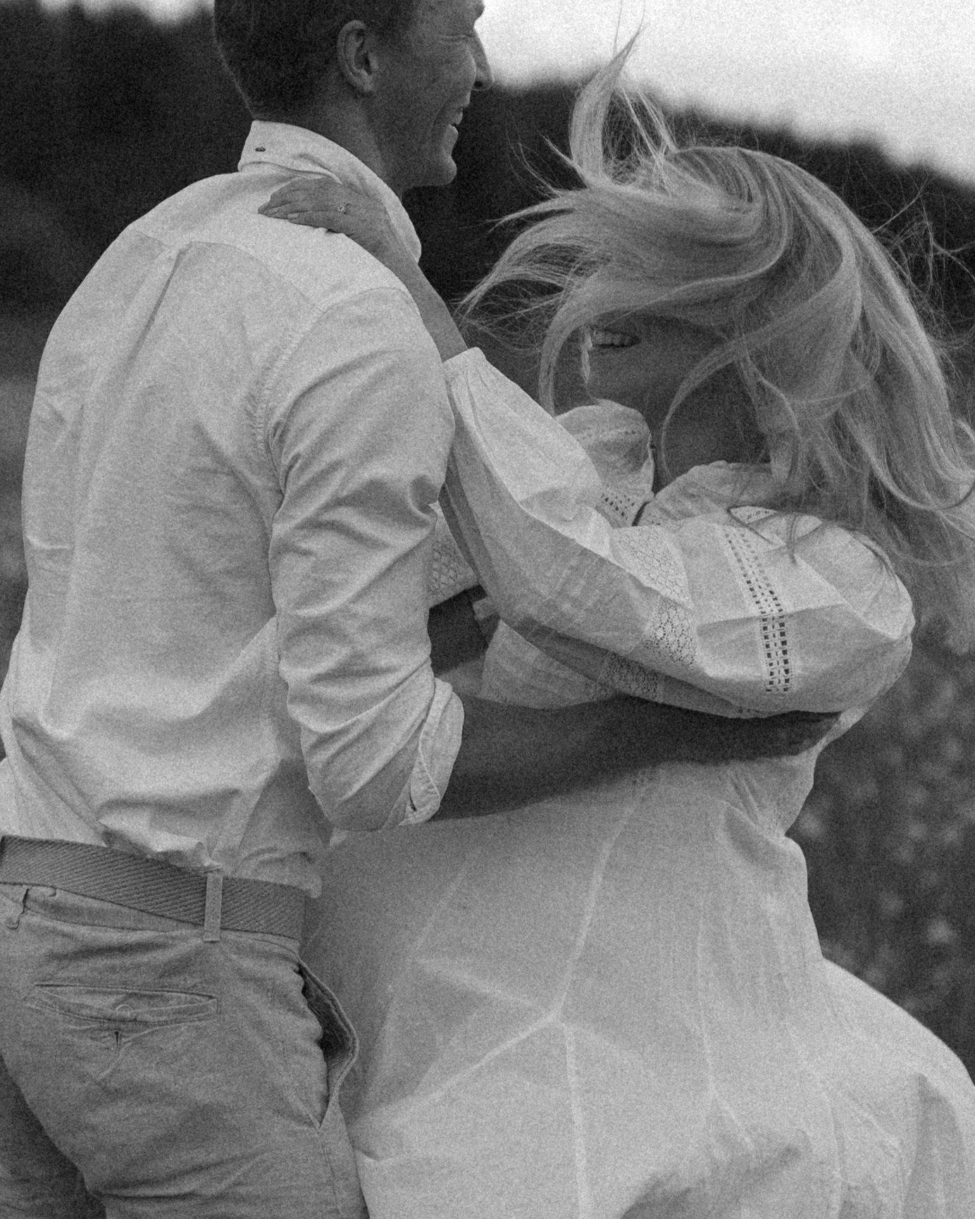 Black and white photo of a couple dancing in formal wedding attire.