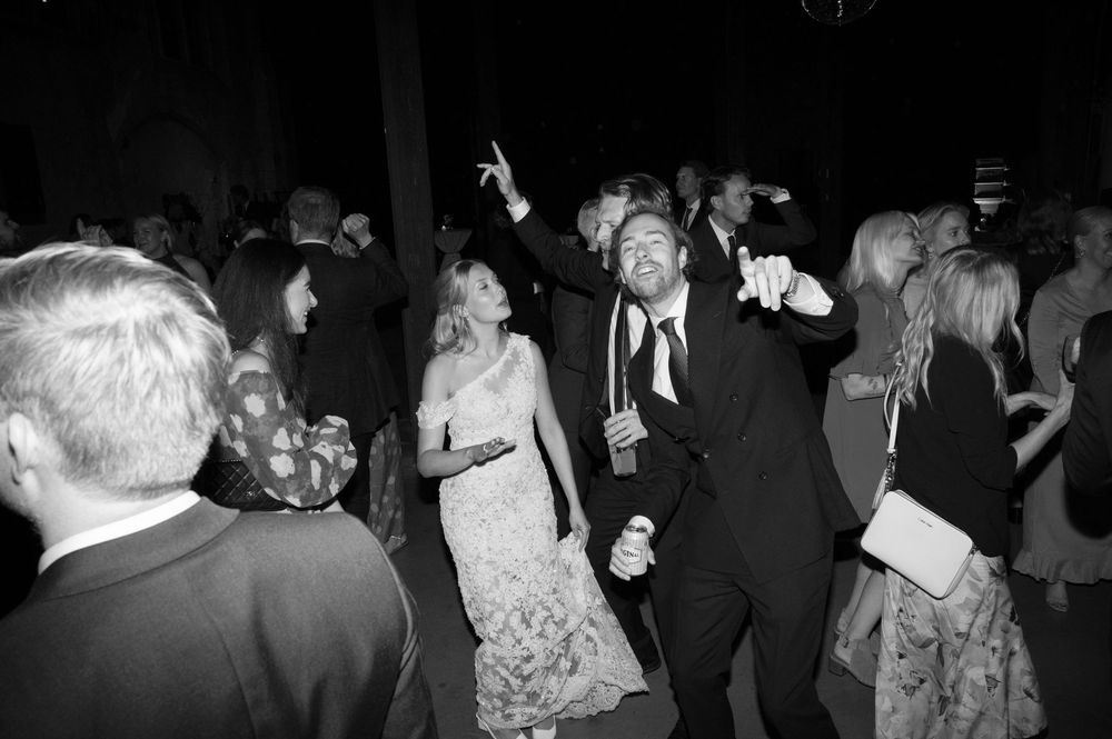 Black and white photographs capturing lively dance floor moments at a celebration.
