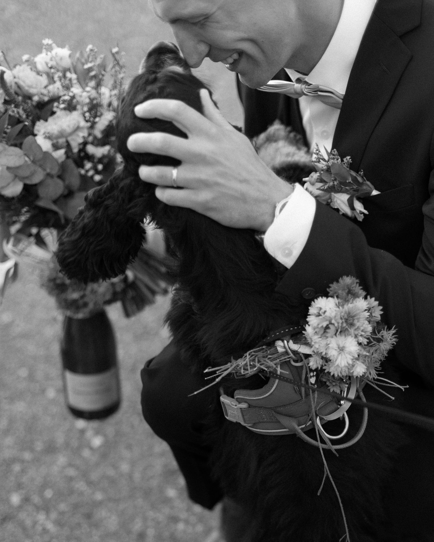 Black suits and floral boutonnieres adorn the wedding party members.