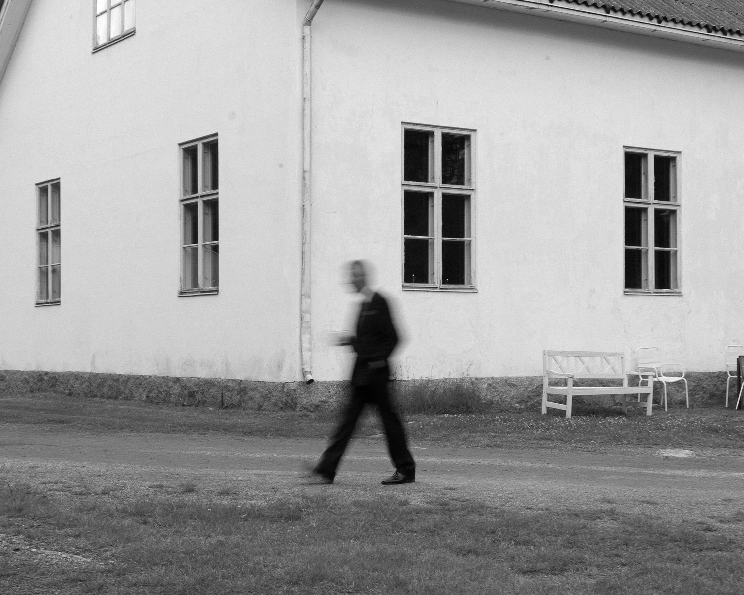 Minimalist architectural shots of a white building exterior with windows and walking figures.
