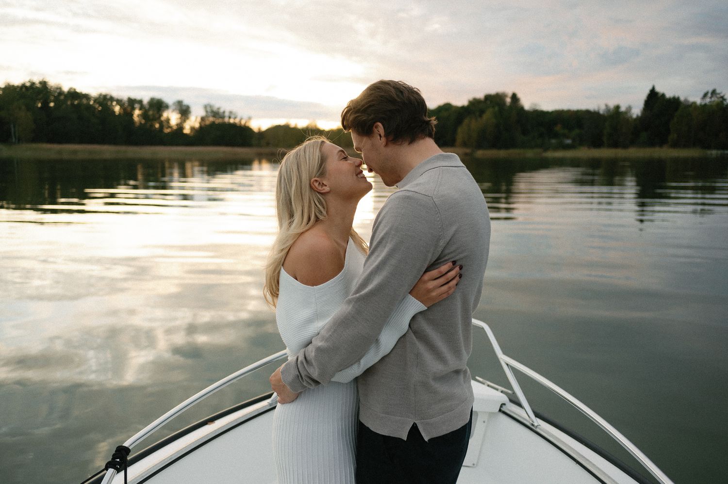 Intimate moments shared between two people on a boat during golden hour.