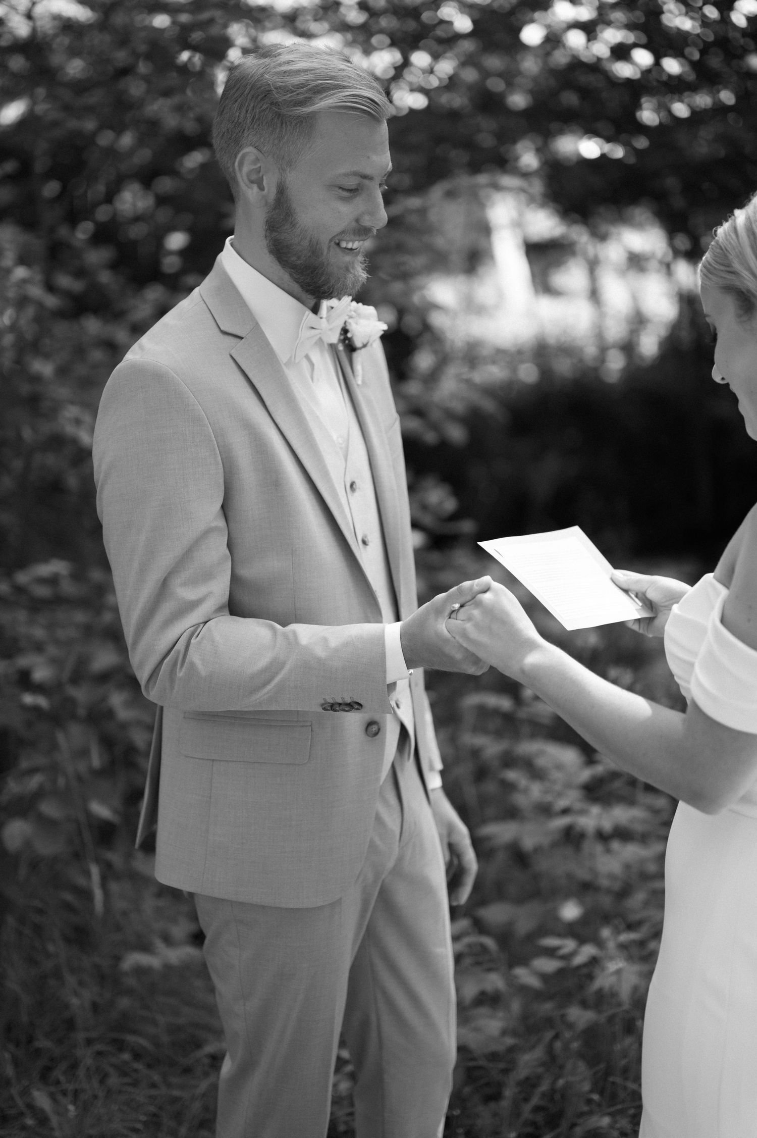 A couple shares a special first look moment before their wedding ceremony in a garden setting.