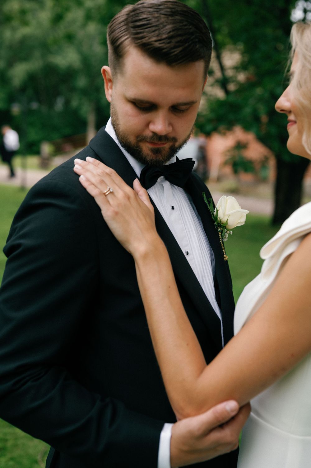 Intimate wedding moment captured in a series of emotional close-up shots against a green outdoor background.
