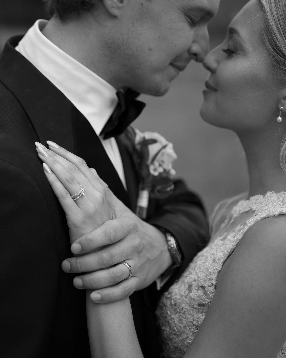 Close-up black and white shot of tender wedding moment.