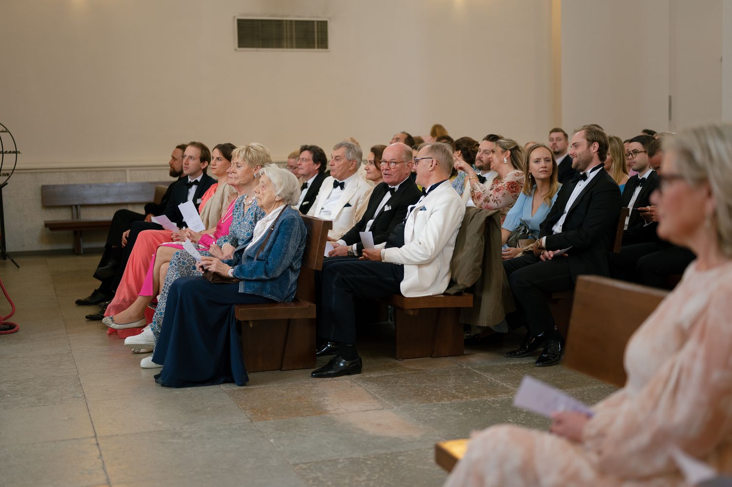 A panoramic view of people seated in rows at what appears to be a conference or presentation venue.