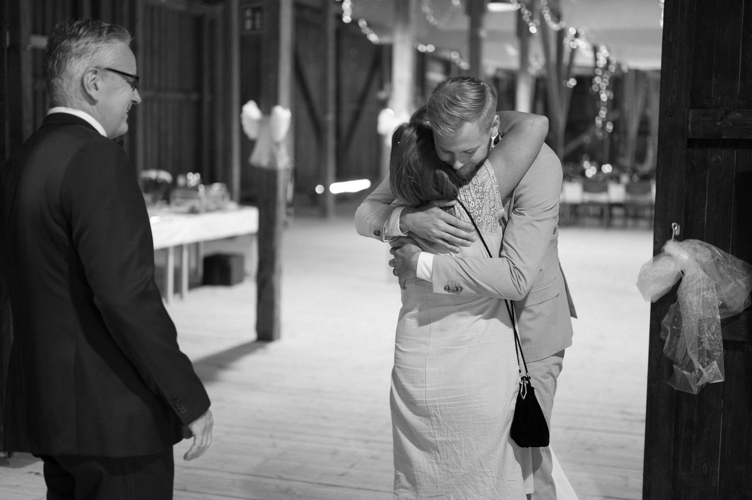 Black and white candid moments captured during wedding reception.