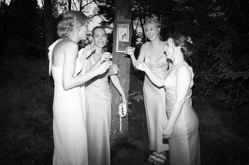 Wedding guests dance and celebrate at an outdoor evening reception.