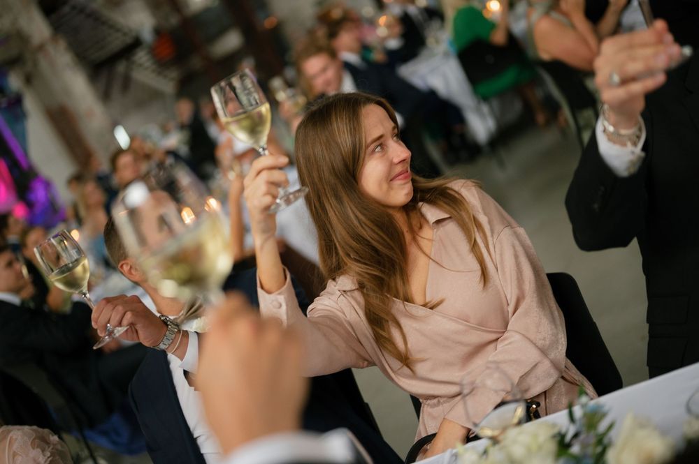 Wedding guests laughing and socializing during reception dinner.