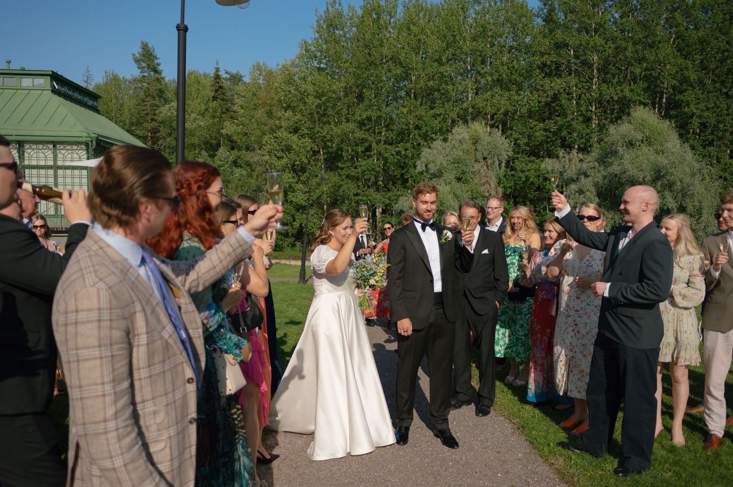 Wedding celebration candids with guests mingling outside historic venue.