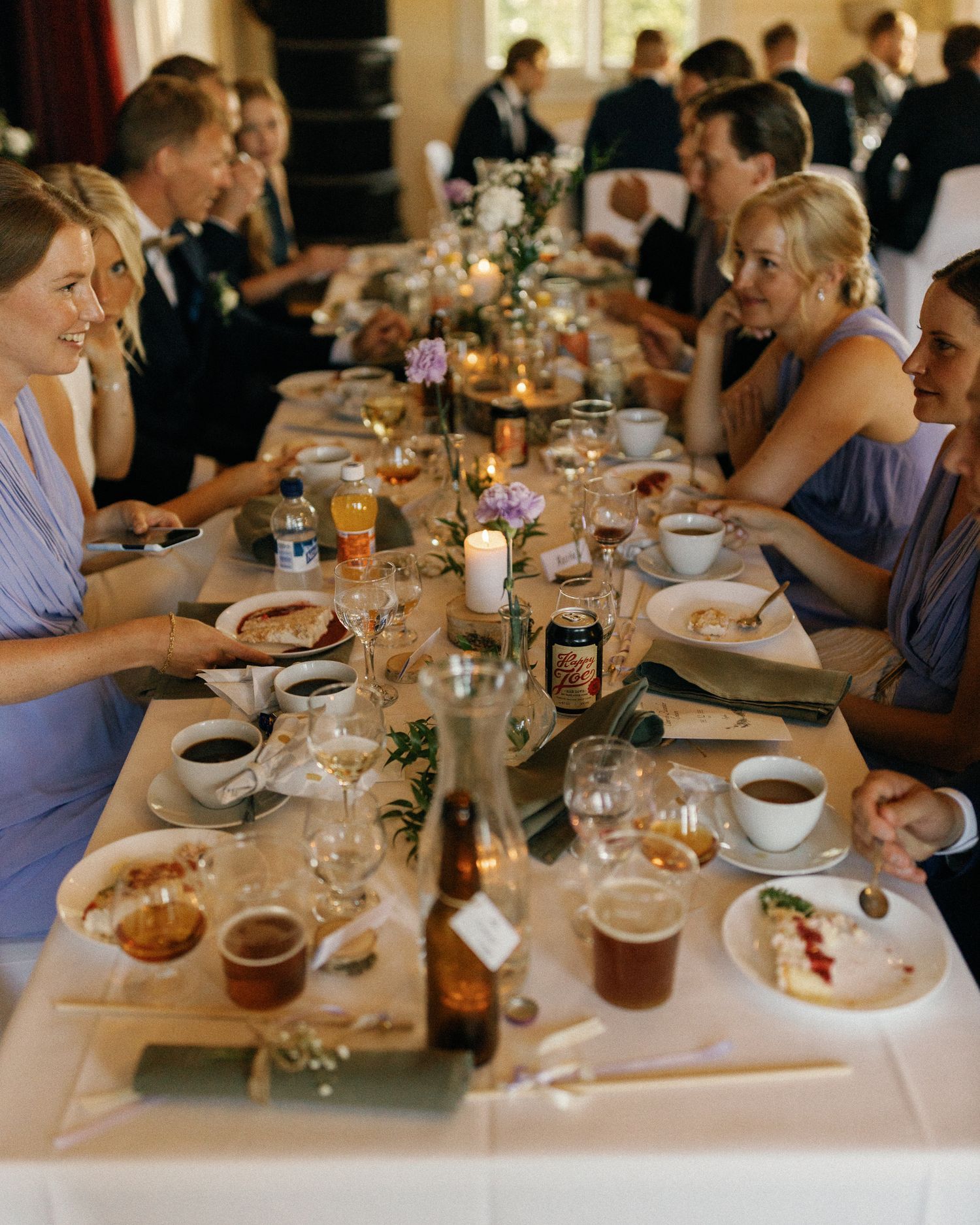 Wedding reception dinner table with guests enjoying a formal meal.