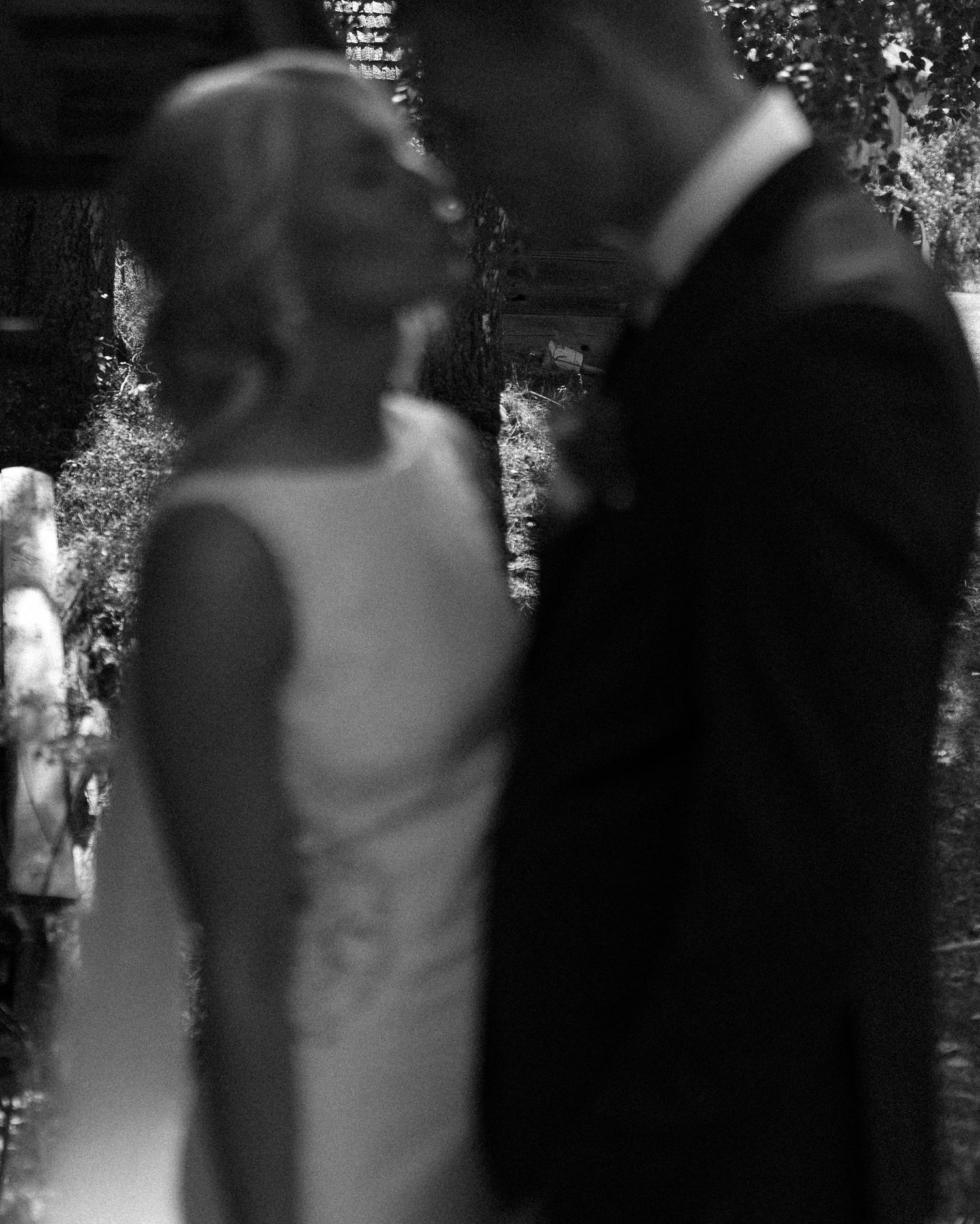 Artistic black and white wedding portraits showing intimate moments between newlyweds.