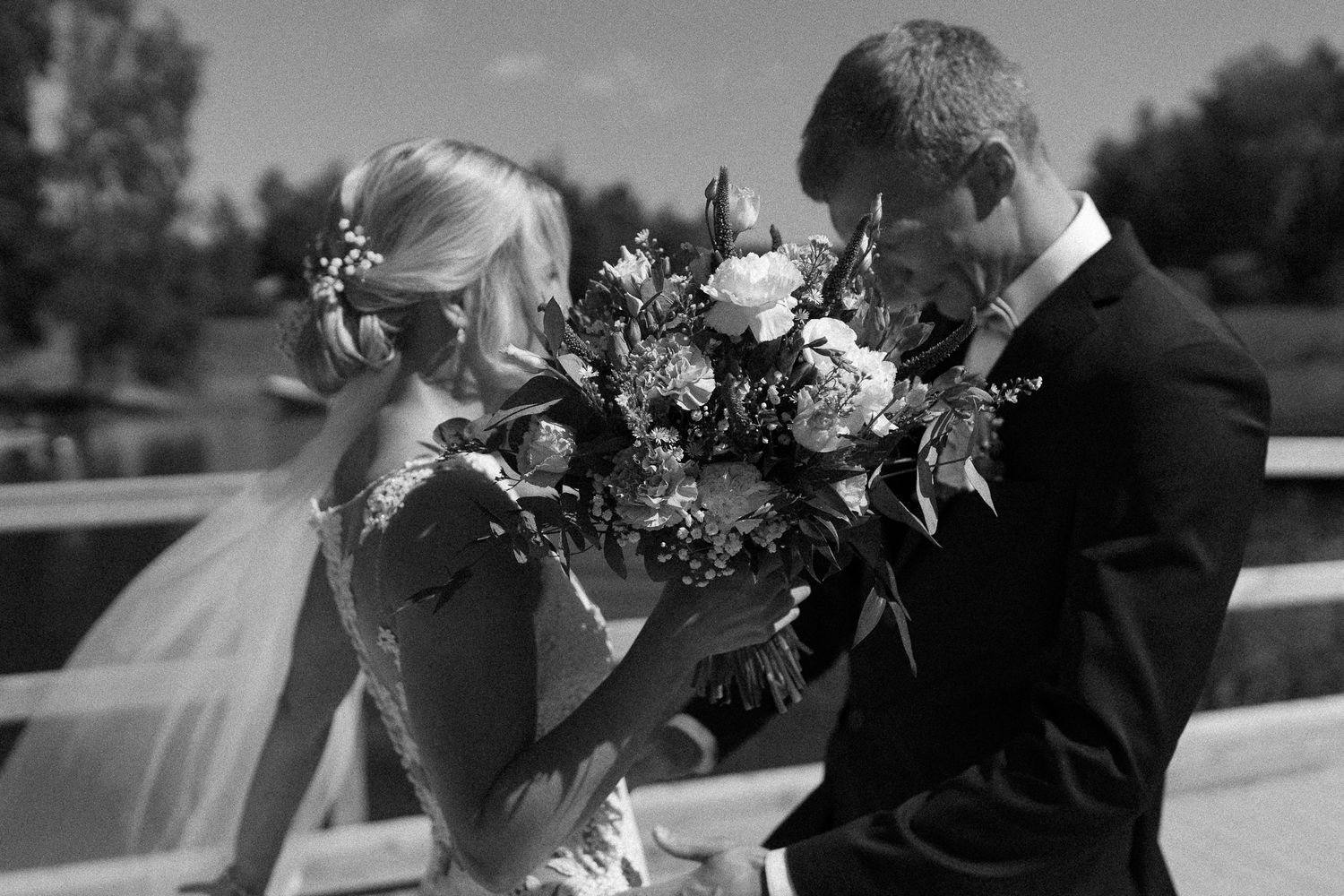 Black and white wedding photo capturing an intimate moment between newlyweds.