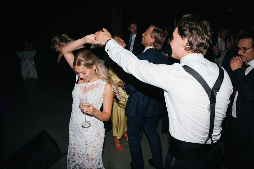 People dancing and celebrating at a festive nighttime gathering.