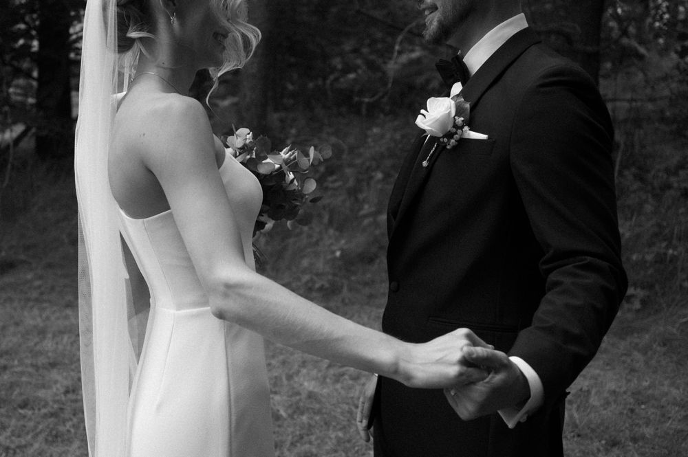 Intimate black and white wedding portraits showing tender moments between newlyweds.