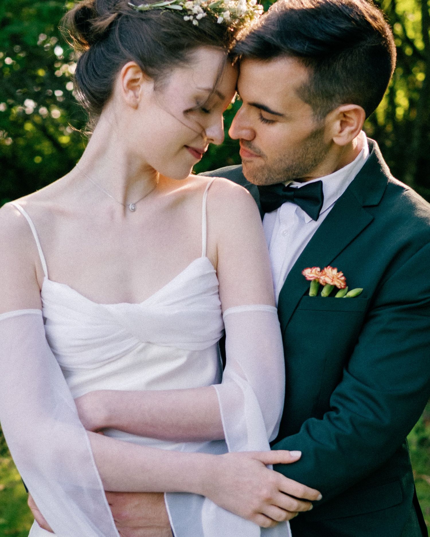 A romantic wedding photo series showing tender moments between a couple in a garden setting.