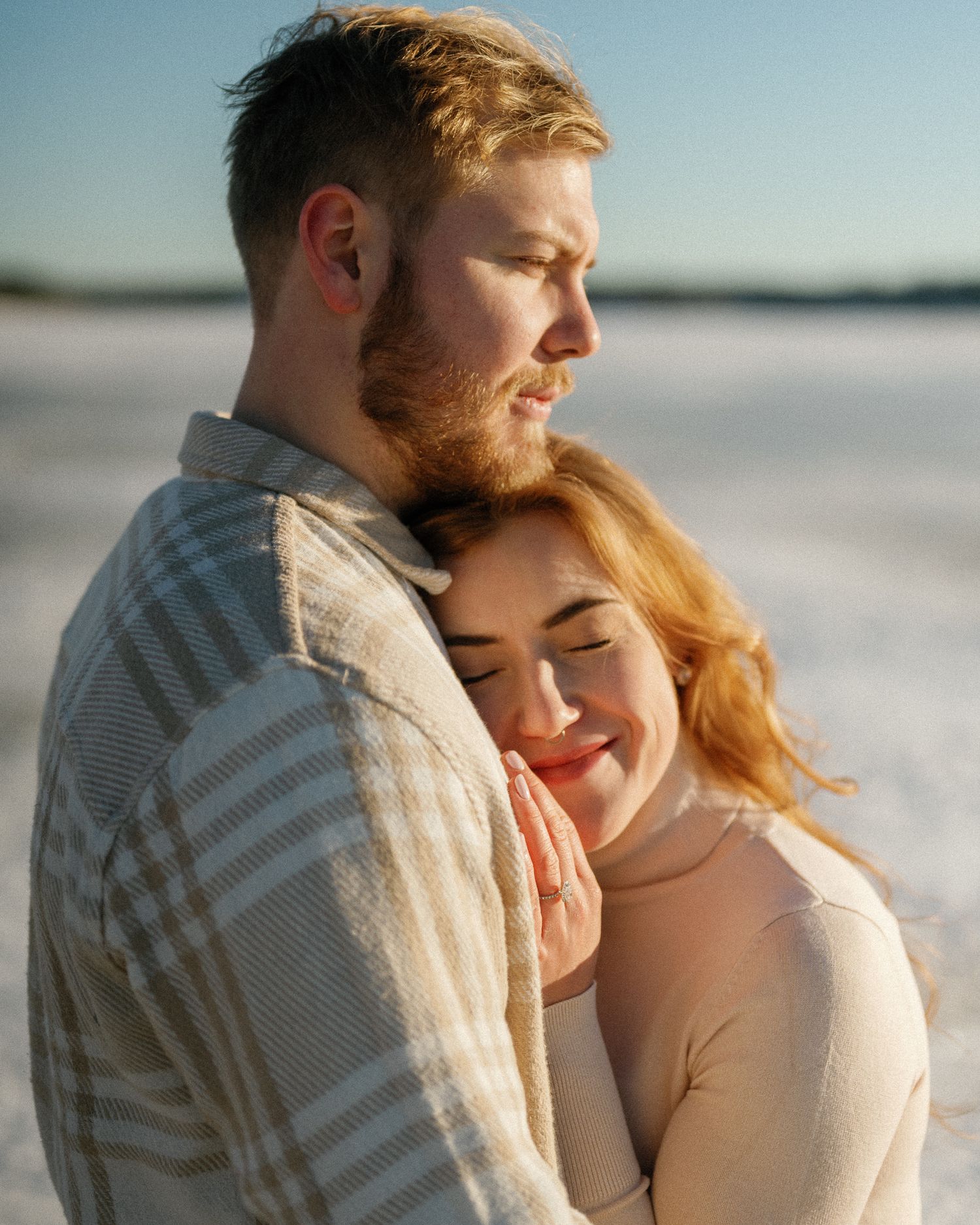 Romantic beach portraits capturing intimate moments during golden hour.