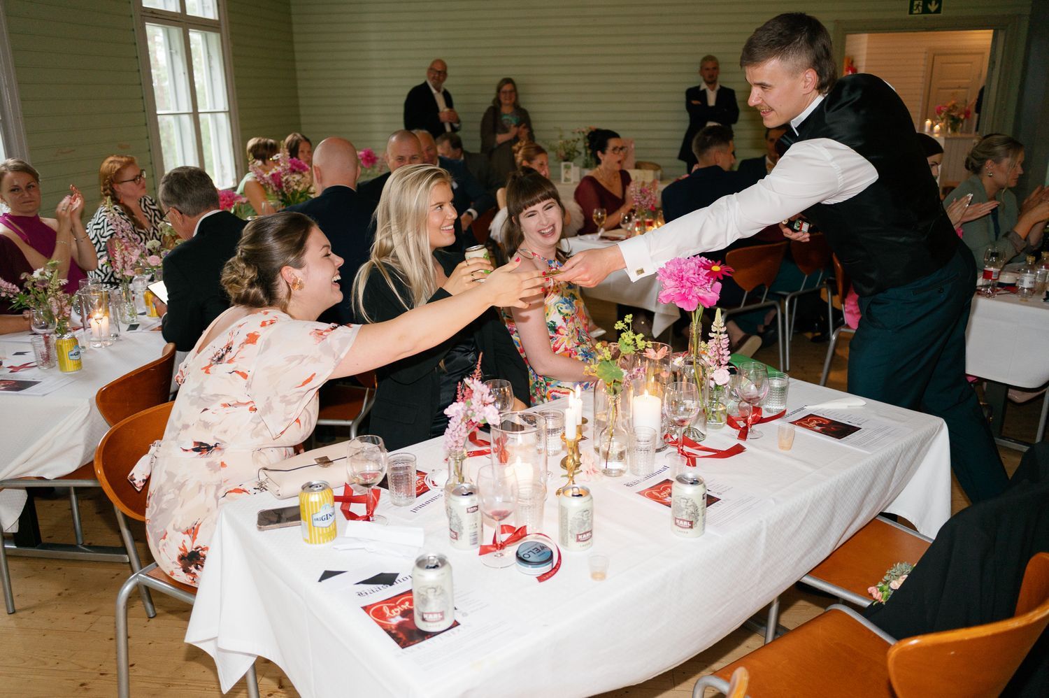 Wedding celebration in a banquet hall with guests enjoying the festivities.